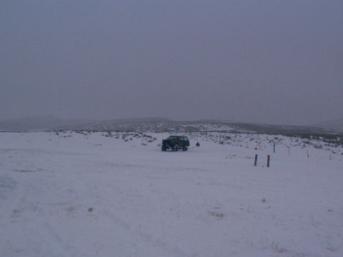 2003 Ford Ranger - A single off-road vehicle sits in a snow-covered landscape under a cloudy sky.