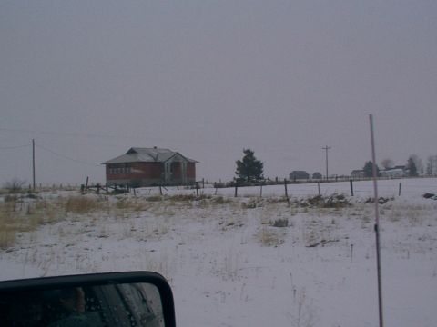 2003 Ford Ranger - Winter scene with a rural building and snow-covered ground.