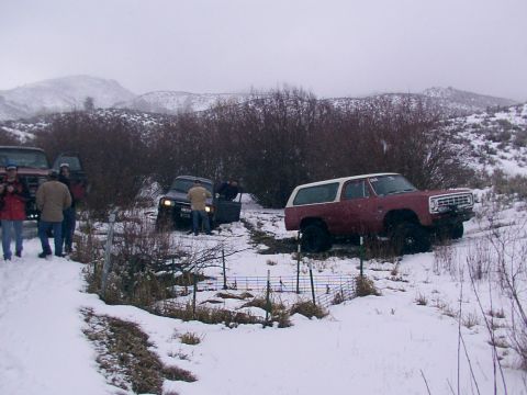 2003 Ford Ranger - Several off-road vehicles are seen in a snowy, outdoor environment with people standing nearby.