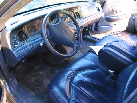 1991 Ford LTD Crown Victoria - The interior of a 1991 Ford Crown Victoria LTD shows blue leather seats and a dashboard with visible gauges.