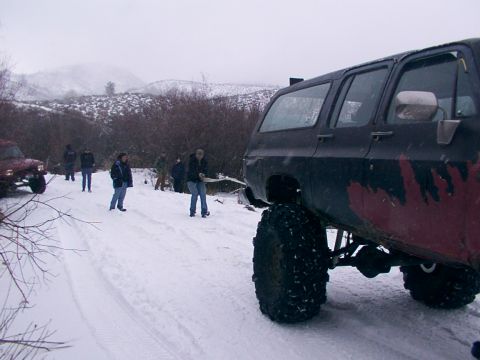 2003 Ford Ranger - Group of people and vehicles in a snowy outdoor scene.