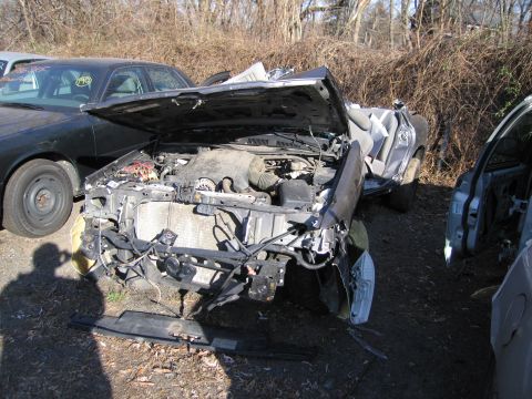 1991 Ford LTD Crown Victoria - This 1991 Ford Crown Victoria LTD shows significant front-end damage, with its hood open revealing the engine compartment.