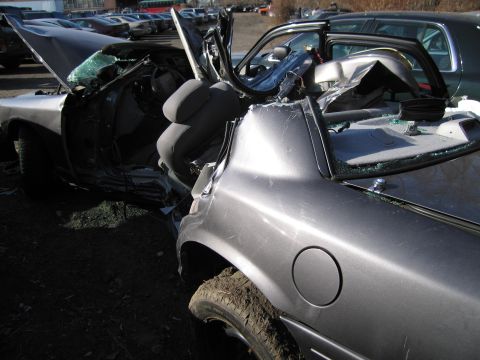 1991 Ford LTD Crown Victoria - This sedan sustained heavy damage, with the front end completely mangled and airbags deployed.