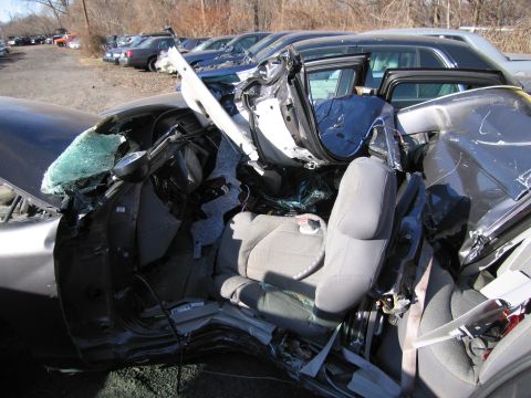 1991 Ford LTD Crown Victoria - The interior of a severely damaged car shows extensive destruction from a collision.