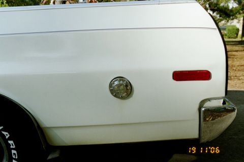 1976 Ford Ranchero - Close-up of the rear passenger side of a 1976 Ford Ranchero, highlighting the fuel filler door and taillight.