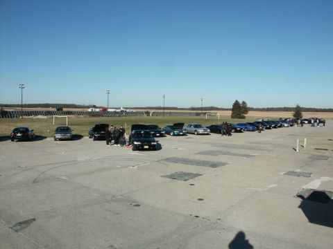 2001 Mercury Grand Marquis - A gathering of sedans, including a 2001 Mercury Grand Marquis, are parked outdoors on a sunny day.