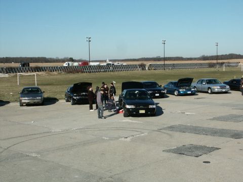 2001 Mercury Grand Marquis - Cars and people gathered at an outdoor event, with a 2001 Mercury Grand Marquis among them.