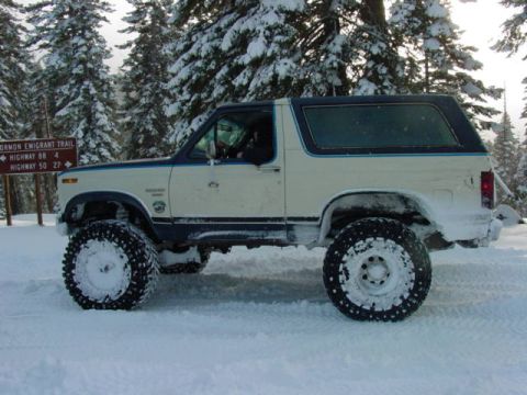 1986 Ford Bronco - 1986 Ford Bronco in a snowy landscape, with a trail sign visible.