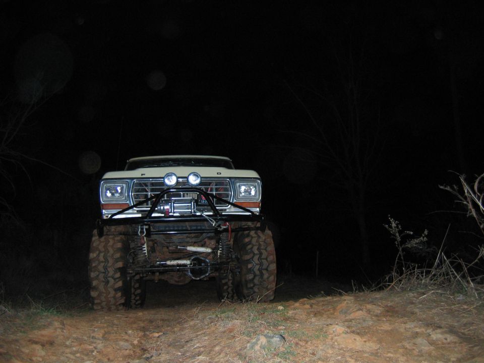 Front view of a lifted 1979 Ford F-Series pickup truck with large tires and a winch