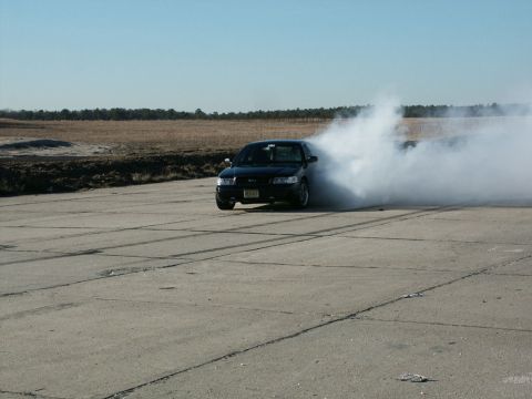 2001 Mercury Grand Marquis - 2001 Mercury Grand Marquis performing a burnout, kicking up a significant amount of tire smoke.