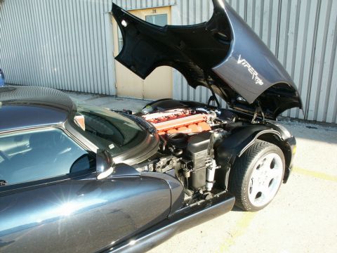 2001 Mercury Grand Marquis - A dark gray Dodge Viper SRT-10 is shown with its hood open, revealing the V10 engine.