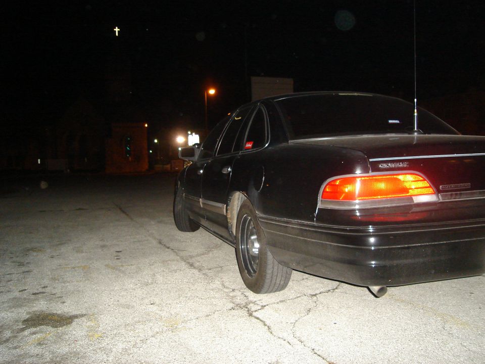 Black 1992 Ford Crown Victoria parked at night