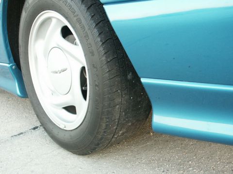 2001 Mercury Grand Marquis - Teal car's front wheel and fender skirt detail. Tire size 225/60R16 is visible.