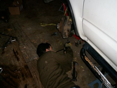 1993 Ford Bronco - Ed removing four lower ball joint bolts and castle nut