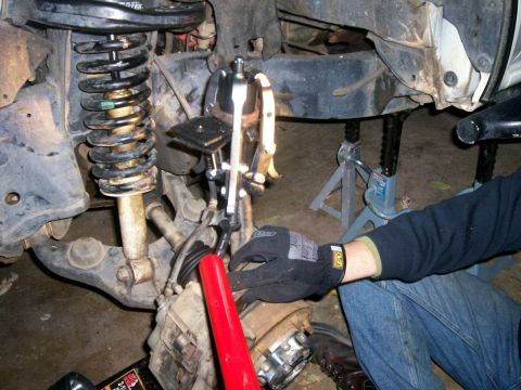 1993 Ford Bronco - Pressing new upper ball joint into knuckle spindle using three jaw puller, harbor freight ball joint cup and two trans jack adapter holder…