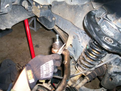 1993 Ford Bronco - Upper ball joint boot wire fastened and tightened around boot