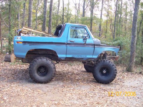 1978 Ford Bronco - A modified 1978 Ford Bronco sits in a forest clearing, its off-road capabilities.