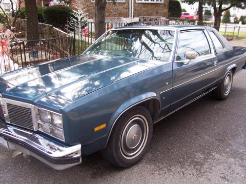 1999 Ford Crown Victoria - This blue sedan has a distinctive grille and chrome accents.