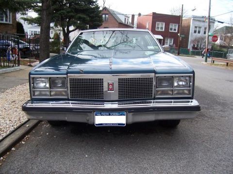 1999 Ford Crown Victoria - The grille and badging indicate this is an Oldsmobile Delta 88, not a 1999 Ford Crown Victoria.