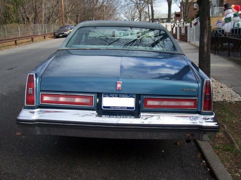 1999 Ford Crown Victoria - Rear view of a blue sedan parked on a street with a New York license plate.