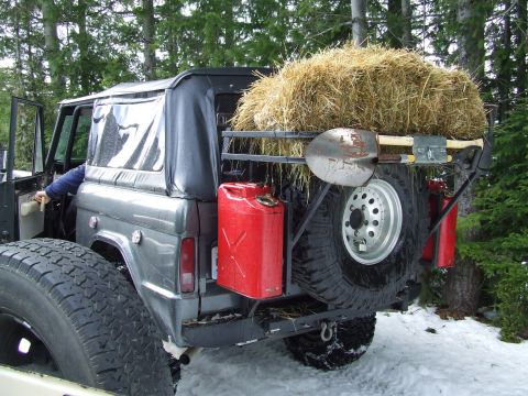 1976 Ford F-150 - This Bronco is equipped for an off-road adventure with essential tools and supplies loaded on the back.