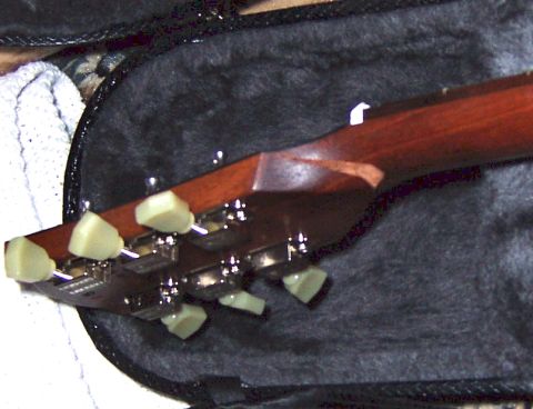 1978 Ford Bronco - A close-up view of a guitar's headstock and tuning pegs, resting within its case.