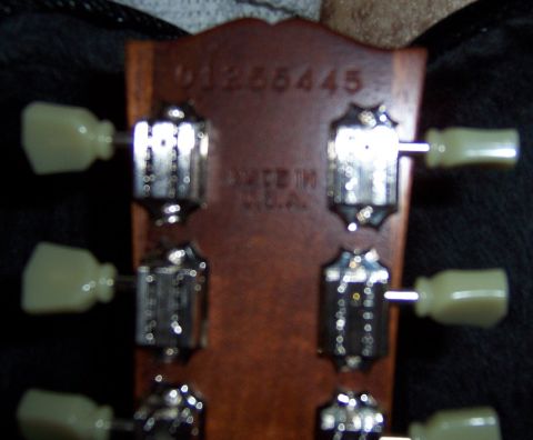 1978 Ford Bronco - Close-up of a guitar headstock with tuning pegs and serial number visible.