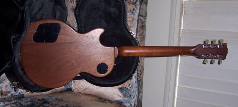 1978 Ford Bronco - The back of a wooden electric guitar is shown in its case, with tuning pegs visible on the headstock.