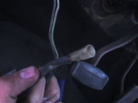 1978 Ford Bronco - Wiring harness and pedal assembly detail in a vehicle's footwell.