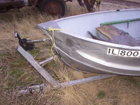 2003 Ford Ranger - An aluminum boat with registration numbers IL 800 is parked on a trailer in a grassy field next to farm equipment.