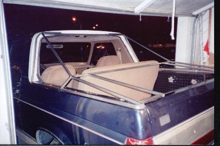 1990 Ford Bronco - Rear view of a 1990 Ford Bronco with a custom metal frame installed in the cargo bed.