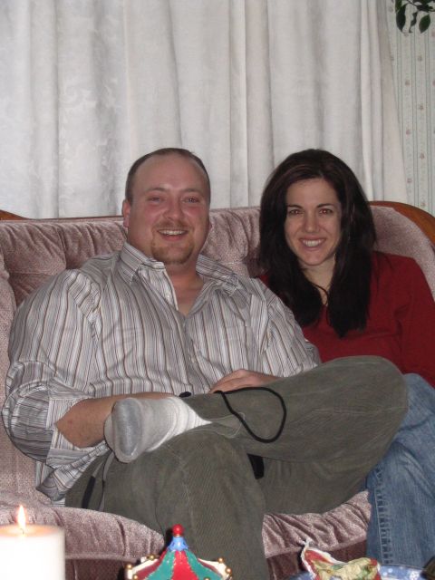 1984 Ford Bronco - A couple smiles while sitting on a couch, with the man's leg in a cast.