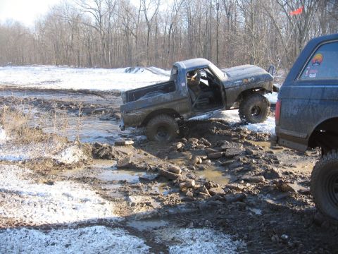 1979 Ford Bronco - A 1978 Ford Bronco navigates a challenging off-road course with deep mud and snow.
