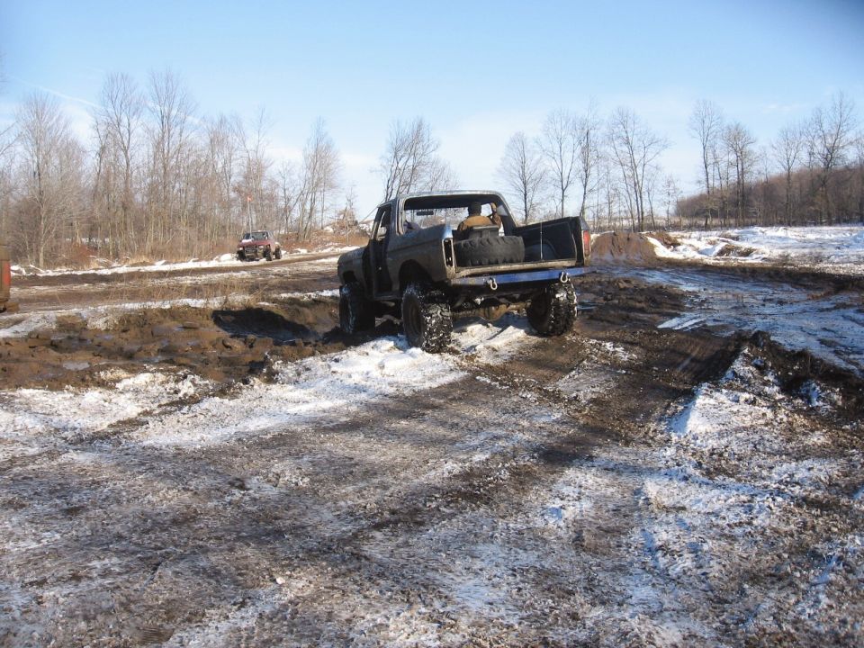 1979 Ford Bronco rear view, off-roading in mud and snow