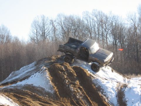 1979 Ford Bronco - Pickup truck navigates a challenging snowy incline during an off-road excursion.