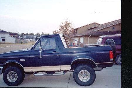 1990 Ford Bronco - This 1990 Ford Bronco is seen from the side, parked next to another SUV.