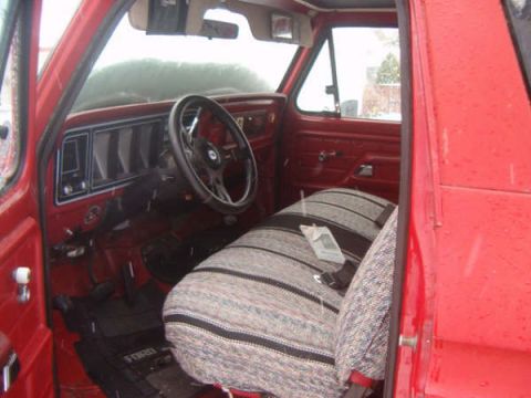 1978 Ford Bronco II - Interior view of a 1978 Ford Bronco II, patterned seat covers and an aftermarket steering wheel.