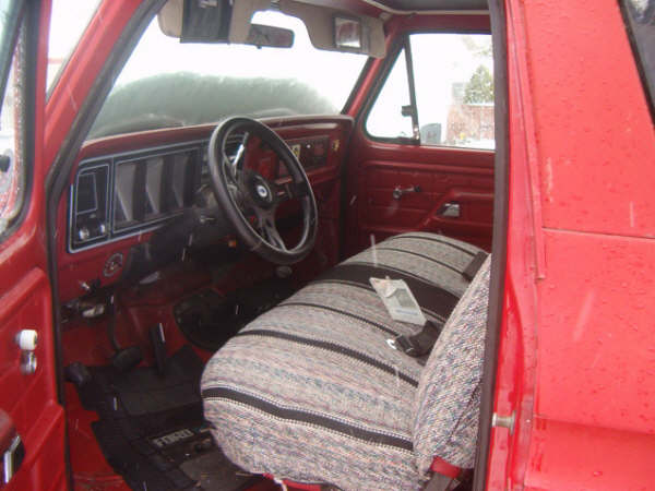 1978 Ford Bronco II interior with patterned seat covers and aftermarket steering wheel
