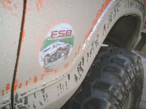 1979 Ford Bronco - A sticker depicting a lifted Bronco is affixed to the mud-covered fender of a vehicle.