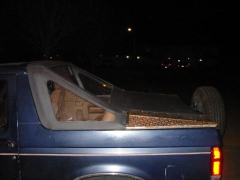1990 Ford Bronco - Rear view of a 1990 Ford Bronco a custom diamond plate tonneau cover and a spare tire mounted externally.