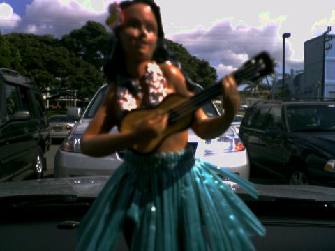 2001 Ford Crown Victoria - A dashboard hula dancer figurine is visible in the foreground, with multiple vehicles parked in the background.