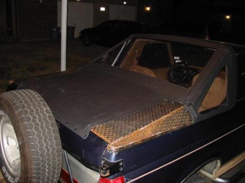 1990 Ford Bronco - This SUV has a custom rear bed cover and a spare tire mounted externally on the left side.