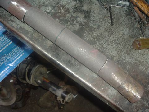 1989 Ford Escort - Close-up of an exhaust pipe with visible cut marks, next to a MagnaFlow catalytic converter box.
