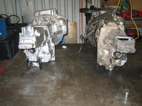 1987 Suzuki Samurai - Two transmissions are shown on a workbench, one appears cleaner than the other.