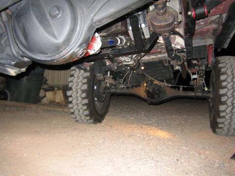 1987 Suzuki Samurai - Close-up of the drivetrain and suspension of a 4x4 vehicle.