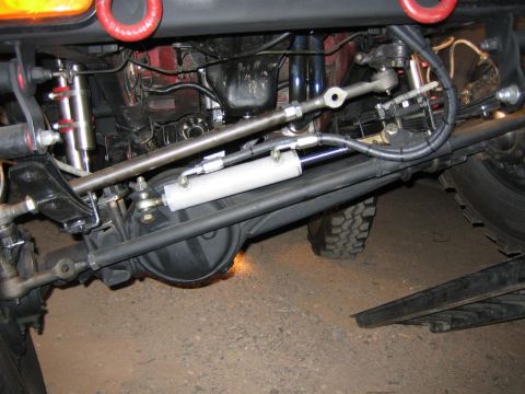 1987 Suzuki Samurai - Undercarriage view shows the complex steering and suspension system of an off-road vehicle.