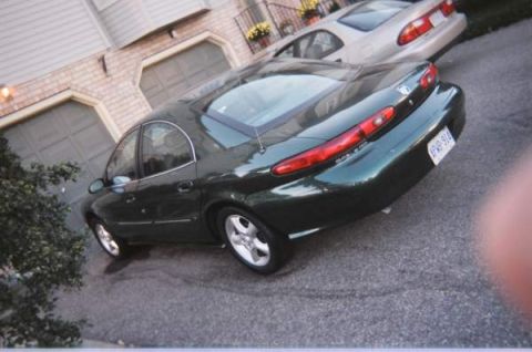 1999 Mercury Sable - A 1999 Mercury Sable is parked in front of a house with a second vehicle behind it.