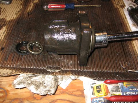 1989 Ford Bronco - Removing the valve housing seal and bearing. I used a large sock and and extension to tap it out. Careful not to damage it!