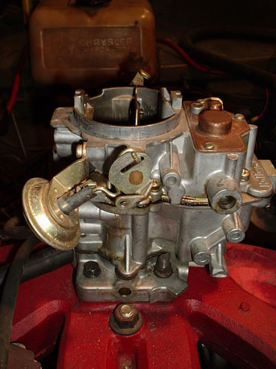1971 Dodge Dart - A Holley carburetor is shown, with a Chrysler Corporation branded container visible behind it.