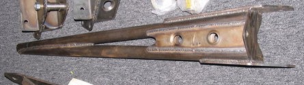1984 Ford Bronco - A close-up view of a fabricated metal suspension part, likely for an off-road vehicle, showing its construction details.